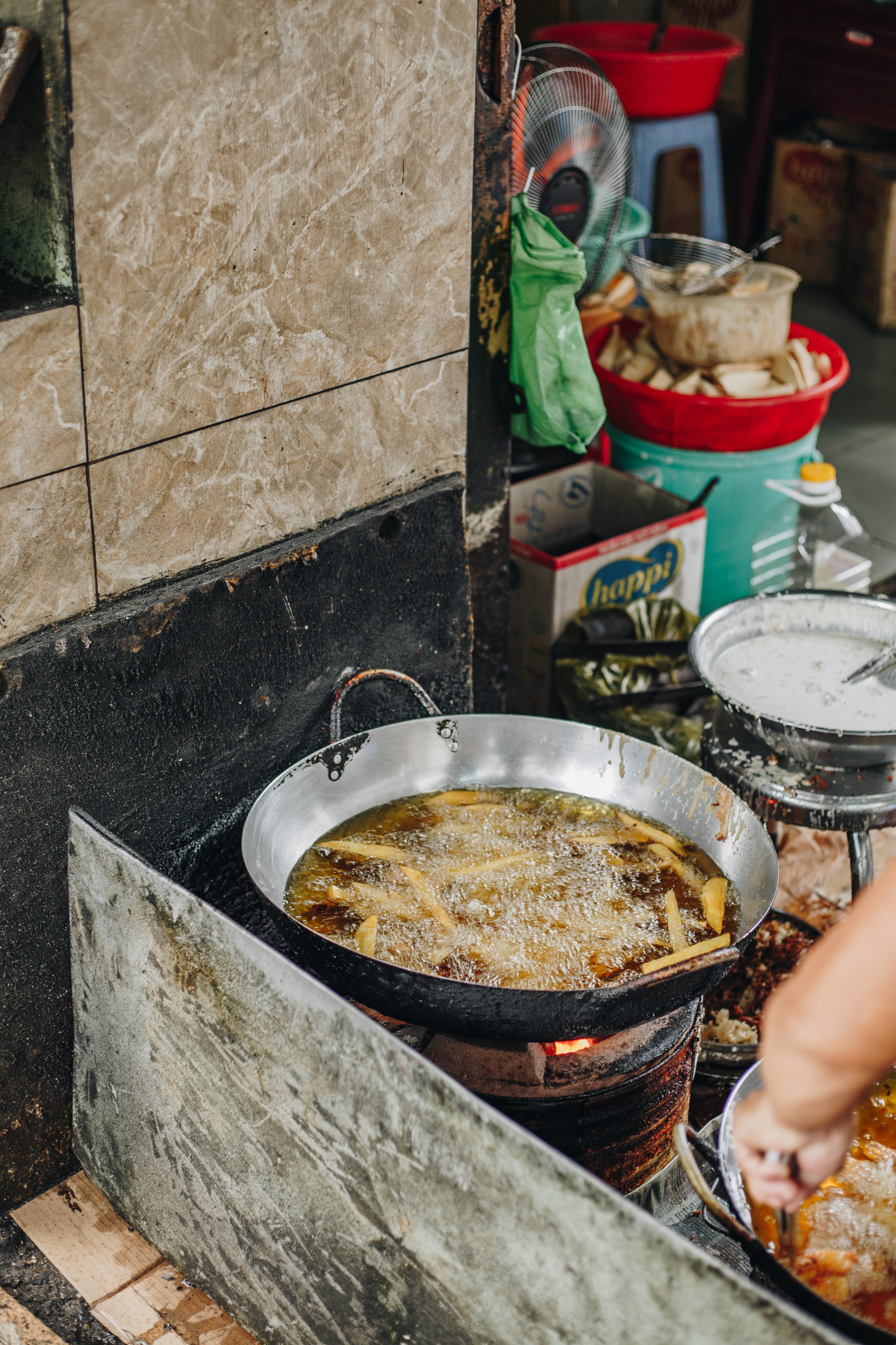 Banana fritters bubbling in a street-side wok in Saigon