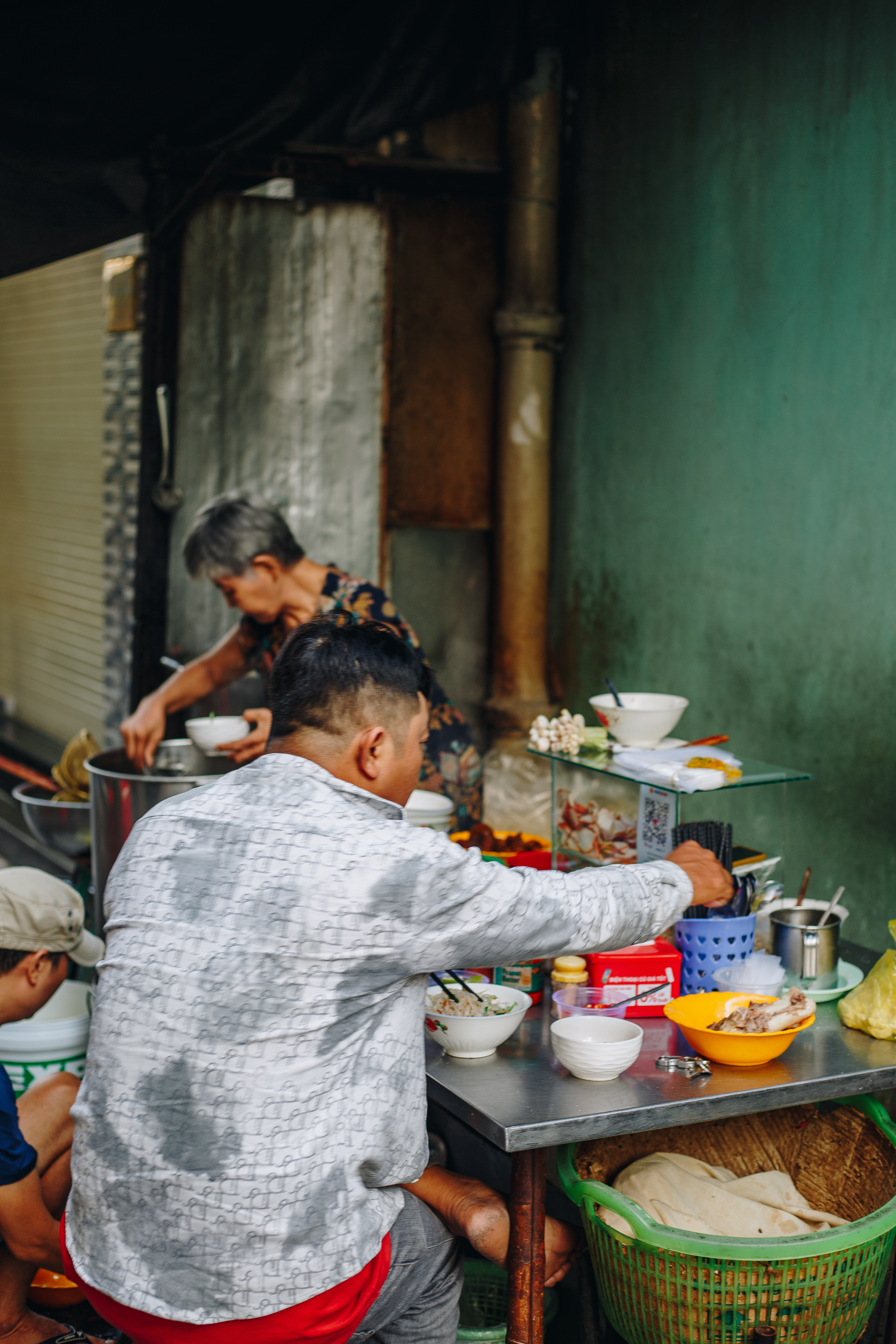 A local noodle stall in a Saigon alley, early morning